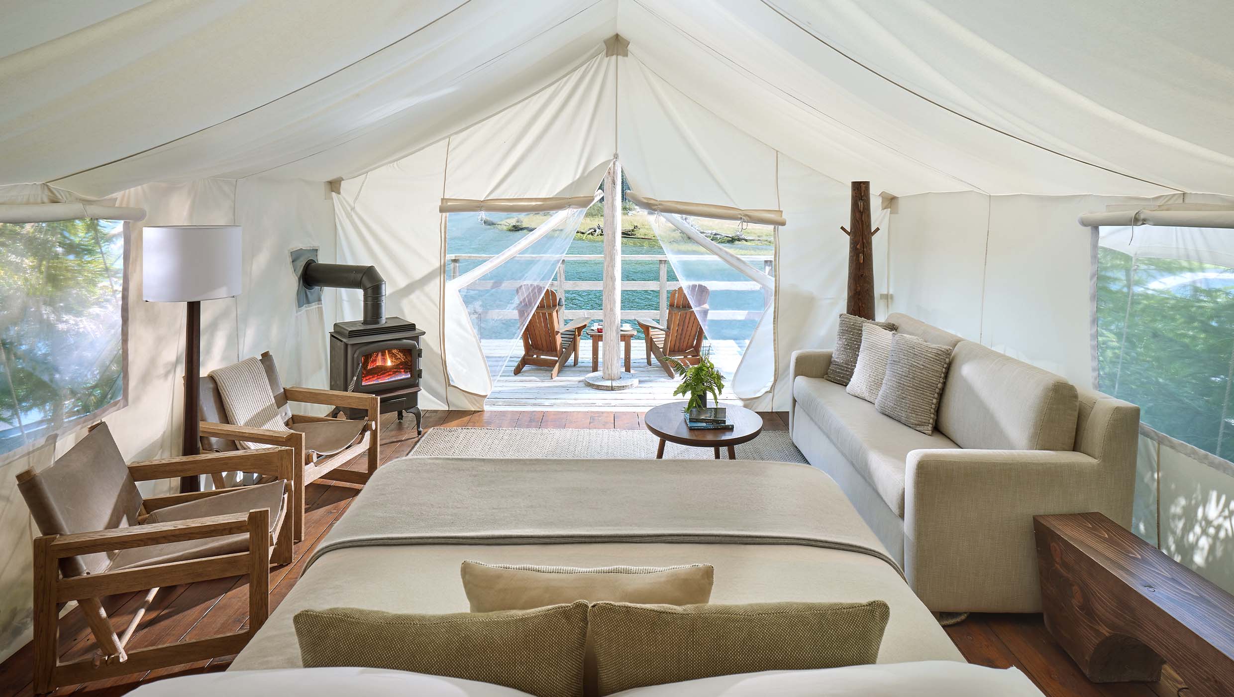 Clayoquot-Wilderness -Lodge-Waterfront-Ensuite Luxury canvas tents at Clayoquot Wilderness Lodge set beside forested mountains and misty inlets on Vancouver Island.