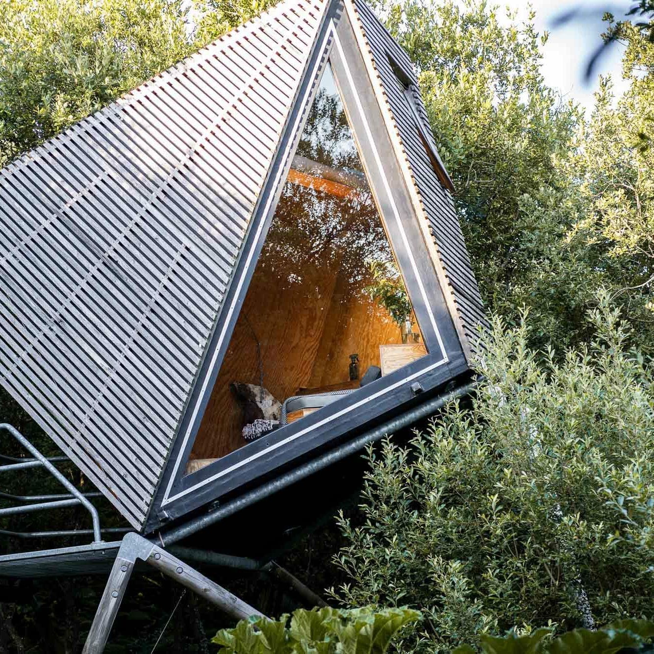 Kudhva Kudhva K3 A-frame cabin surrounded by trees — sustainable off-grid hideaway in Cornwall’s landscape hotel.