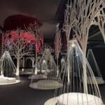 QC Terme Milano outdoor thermal bath surrounded by historic walls and lush gardens in Milan, Italy.