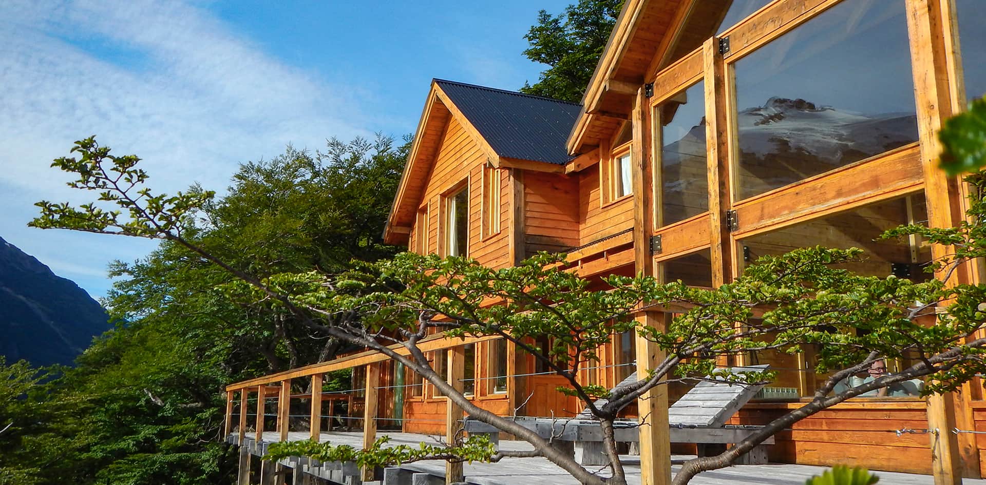 Aguas Arriba Lodge overlooking turquoise Lago del Desierto with Fitz Roy in the distance, Patagonia.